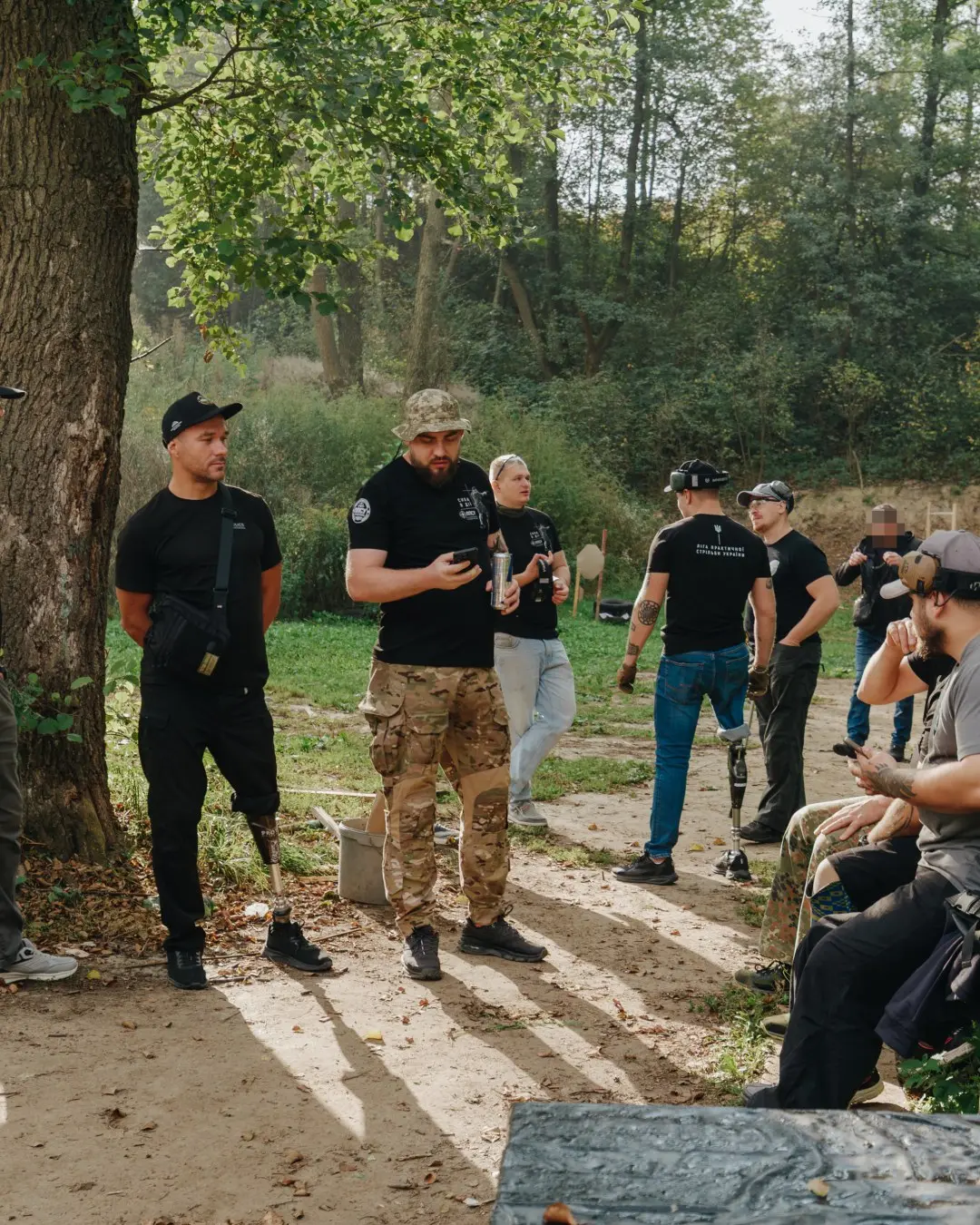 Participants between stages under a tree