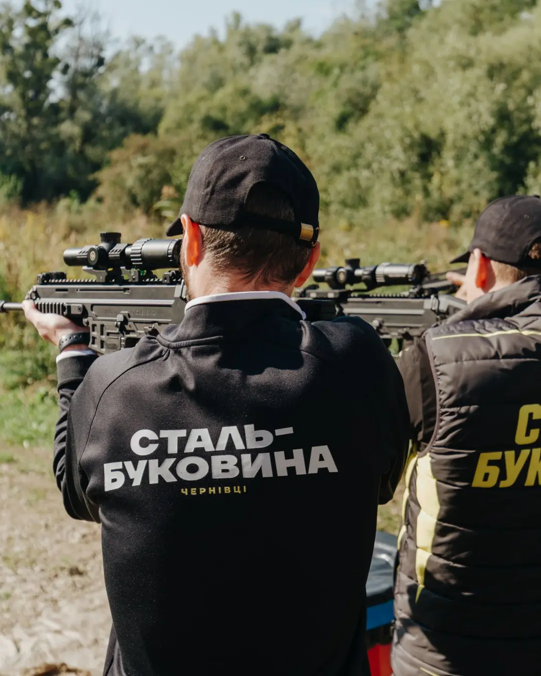 Two participants fire carbines side by side